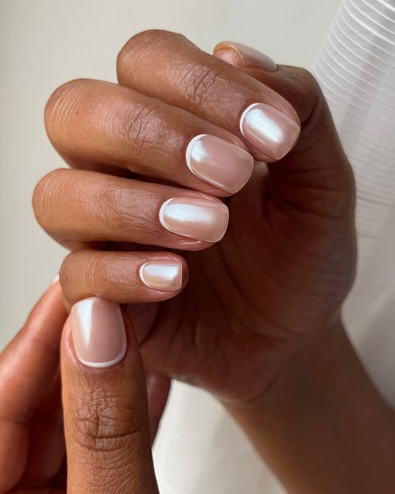 Short square nails with pearly nude shimmer, elegant nail trend.