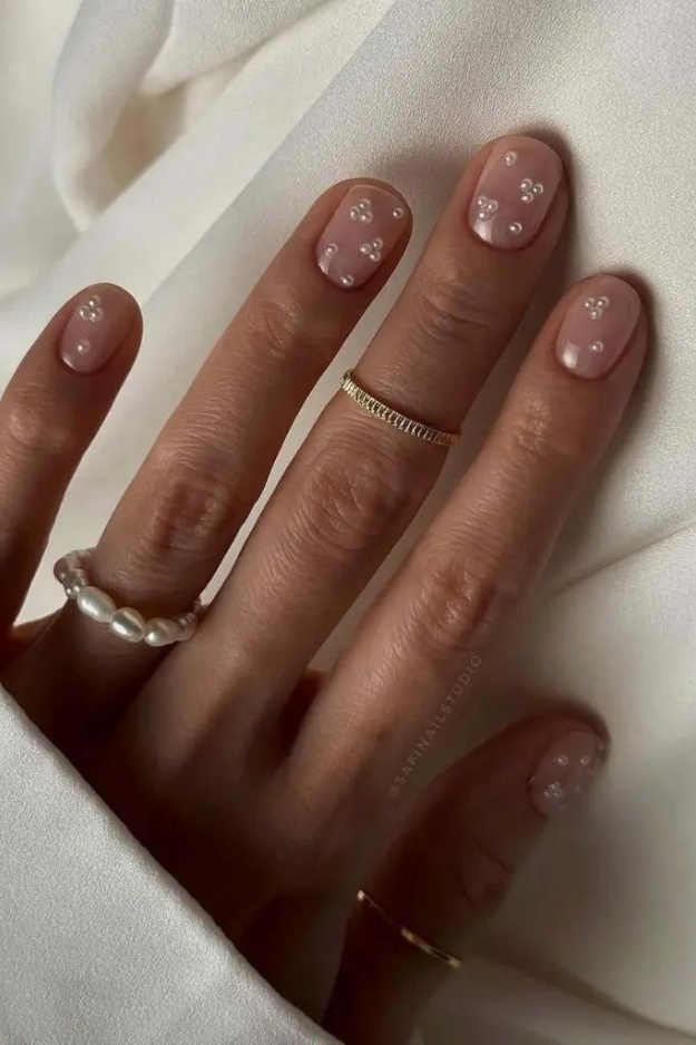 Short square nails with pearl dot accents, delicate and feminine.