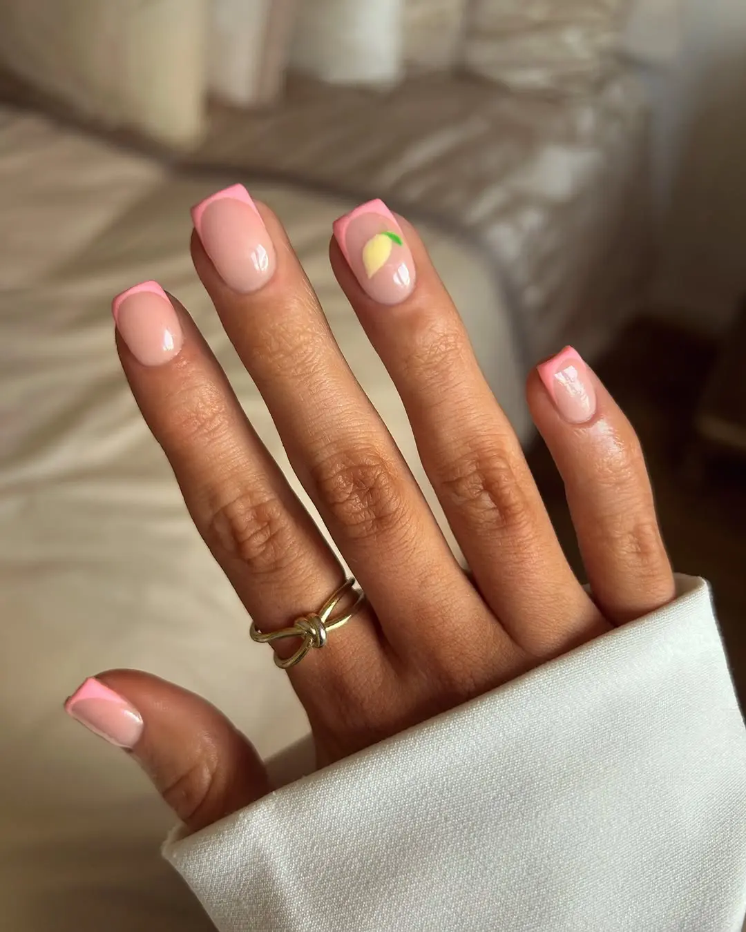 Short square nails with pink and lemon accents, vibrant and fresh.