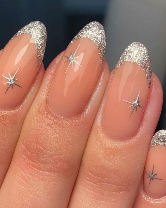 Glittery silver nails with star accents, celestial nail design