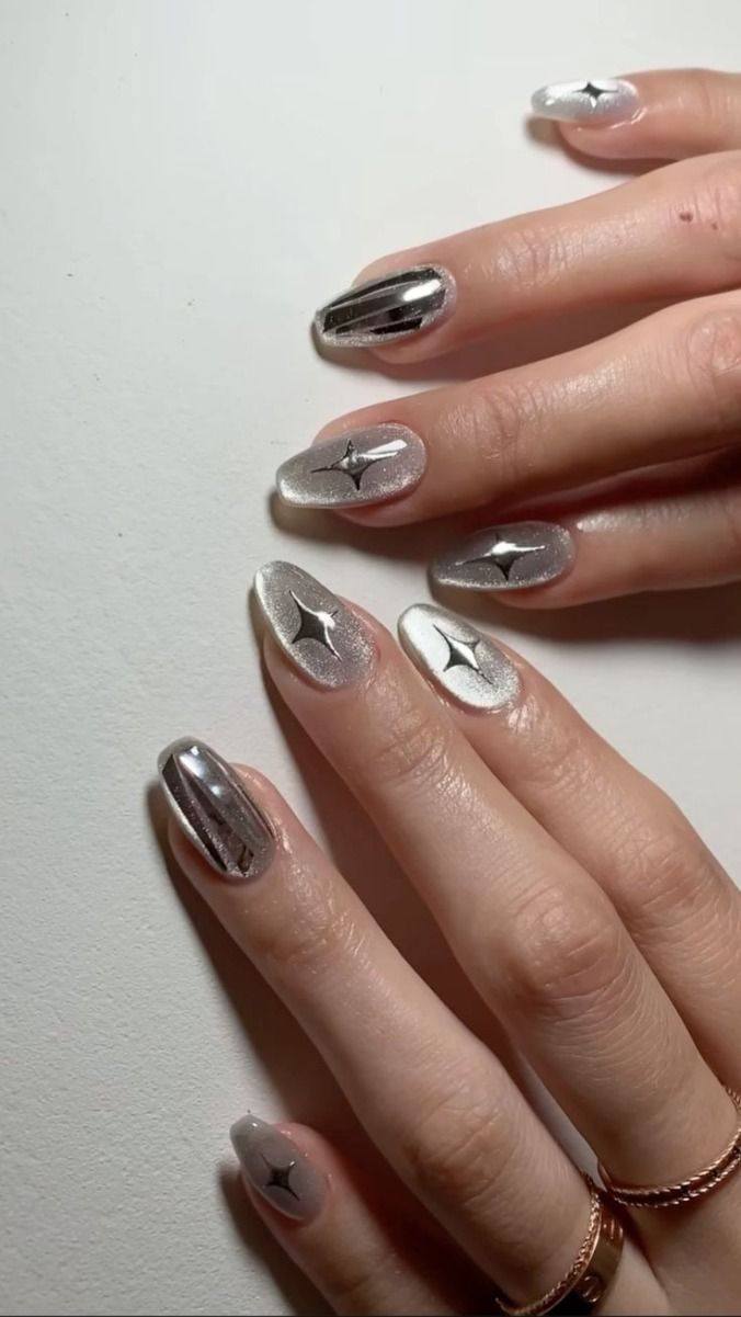 Silver nails with reflective star accents, futuristic nail trend