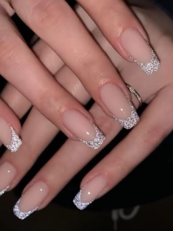 Nude nails with silver glitter tips, modern French nail art