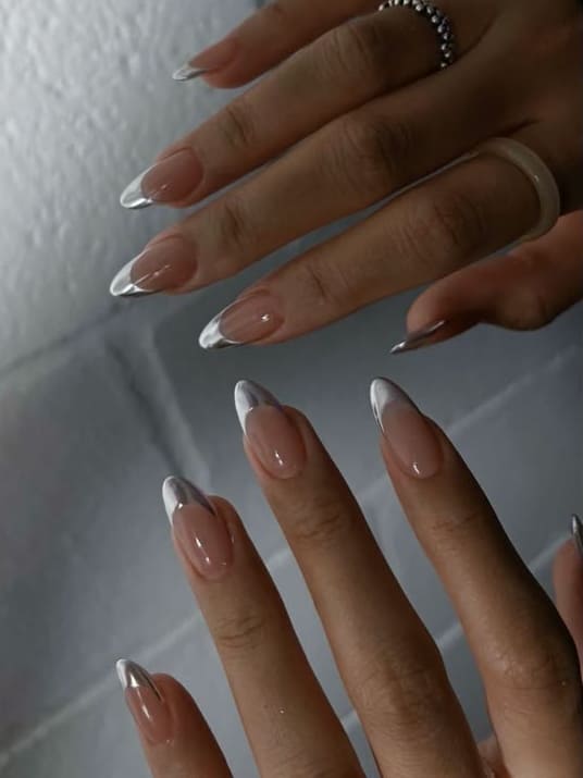 Almond nails with sleek silver tips, modern French manicure