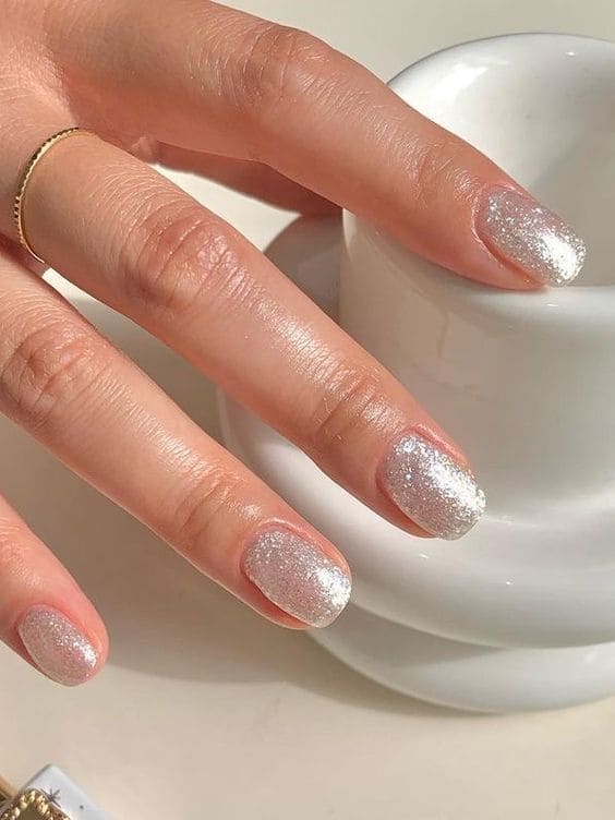 Short nails with textured silver glitter, festive nail style