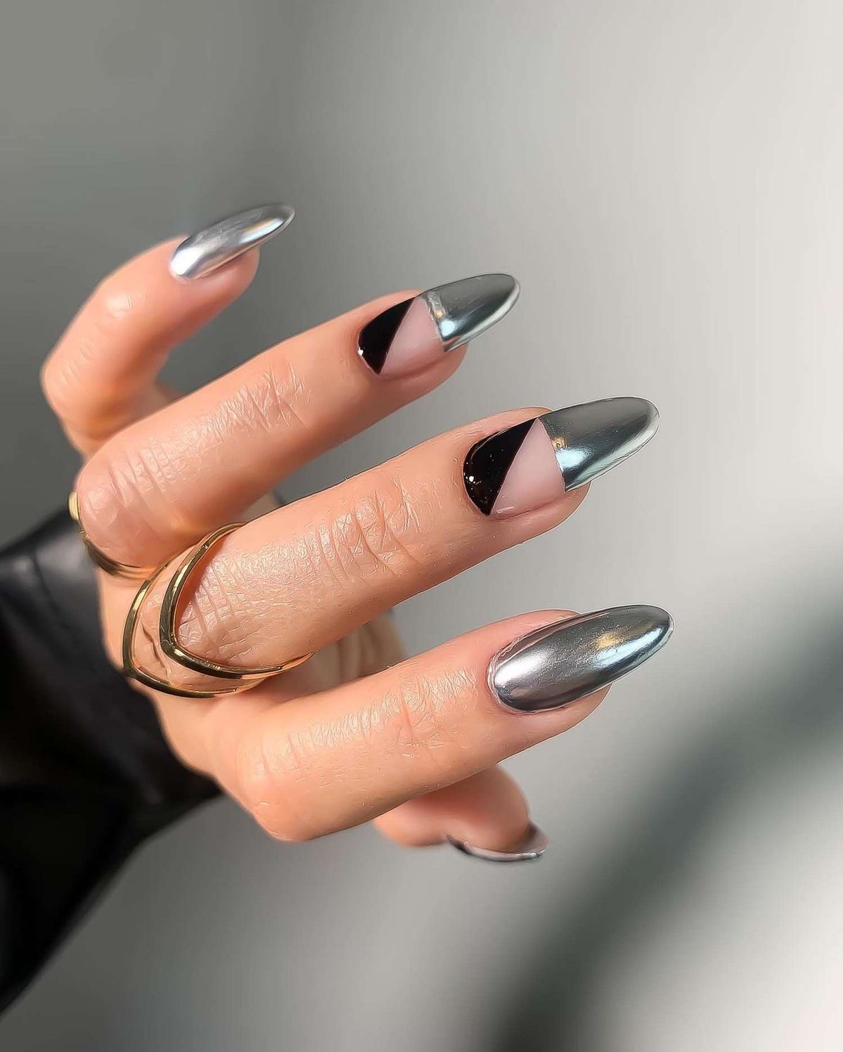 Almond nails with geometric silver design, bold nail art