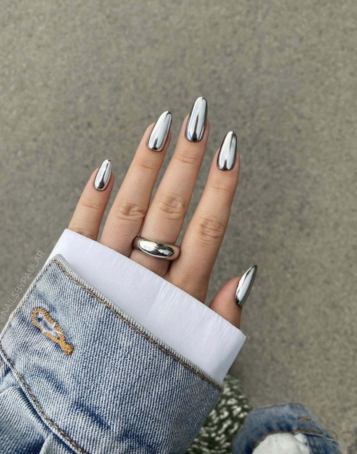 Long stiletto nails with silver chrome finish, bold manicure