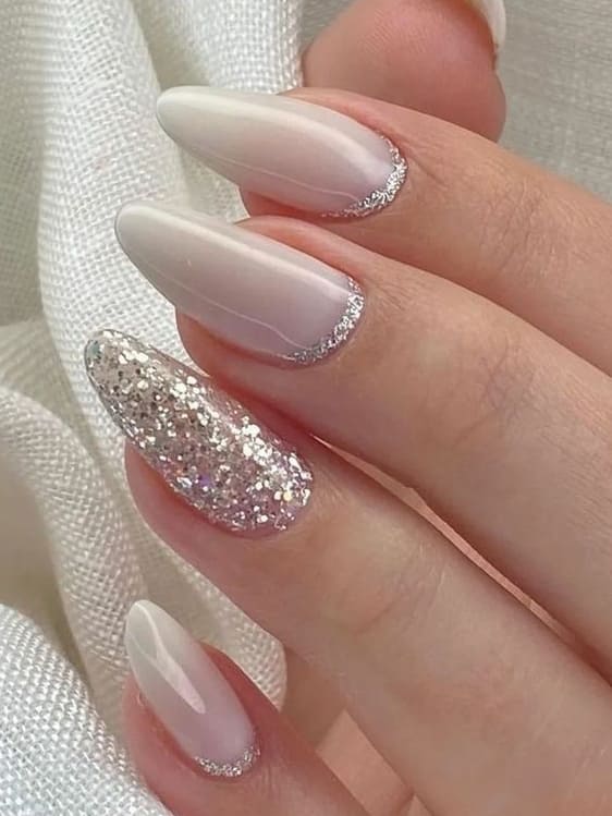 Almond nails with silver accents and glitter, elegant nail art