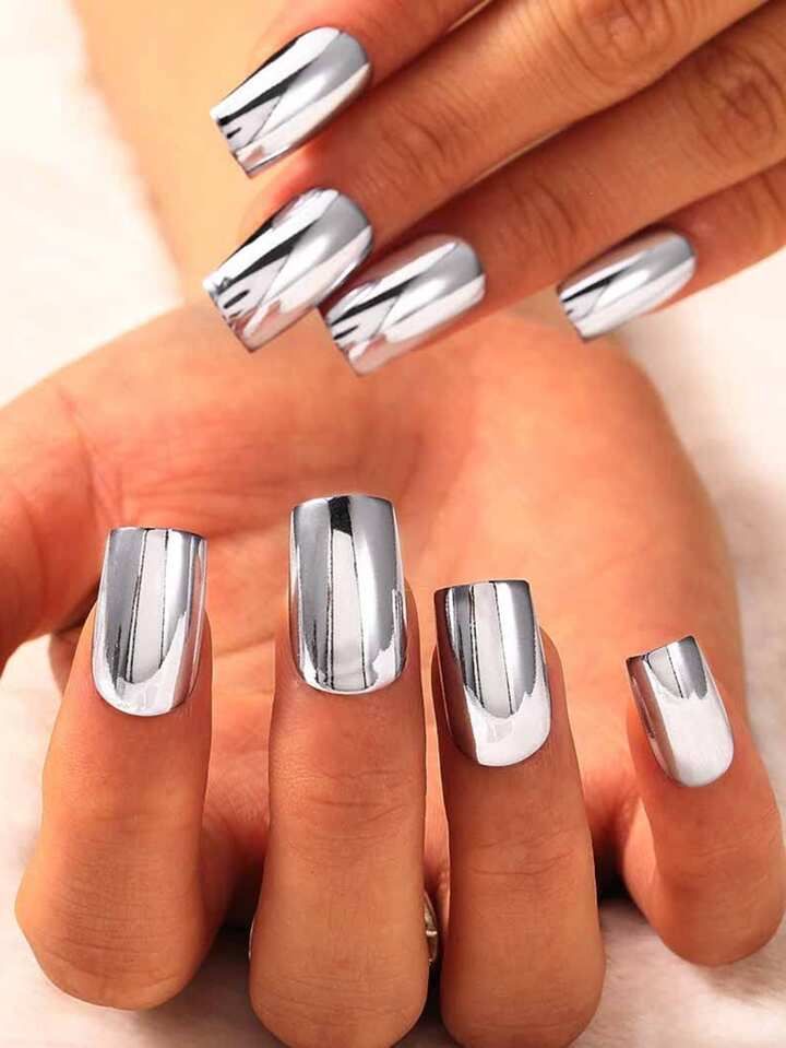 Short square nails with mirror chrome finish, striking nail art
