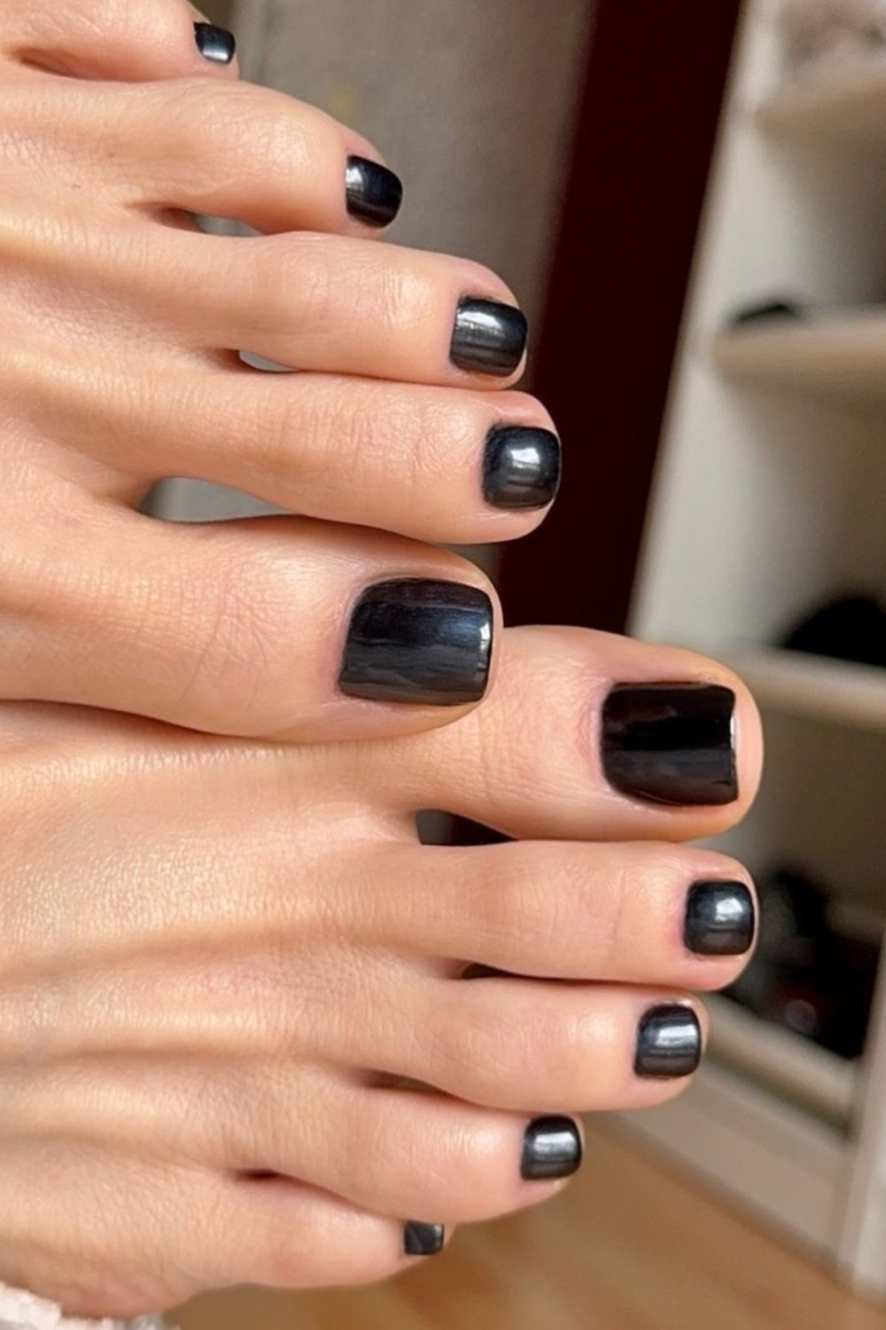Glossy black toe nails with a chic finish