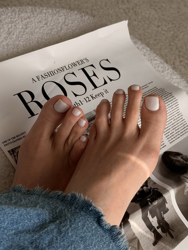 Minimalist white toe nails with a glossy finish