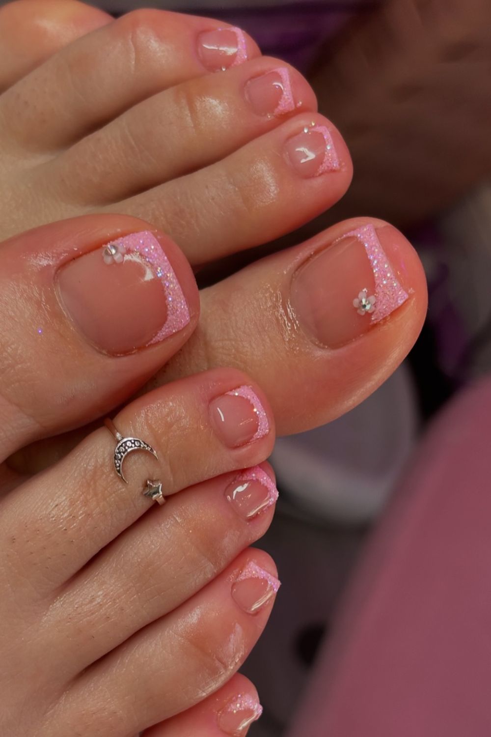 Pink French tip toe nails with glitter accents