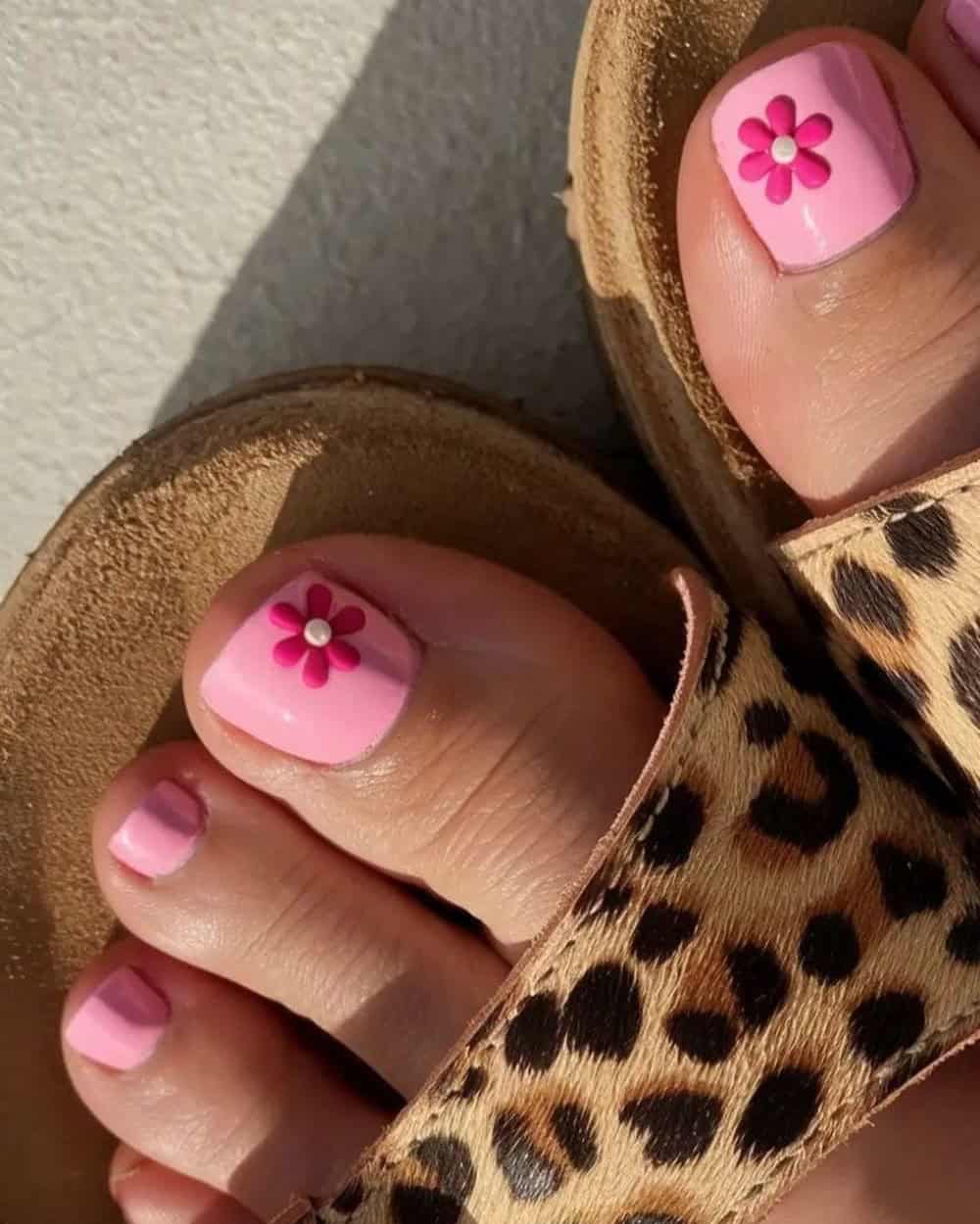 Pink toe nails with playful flower designs