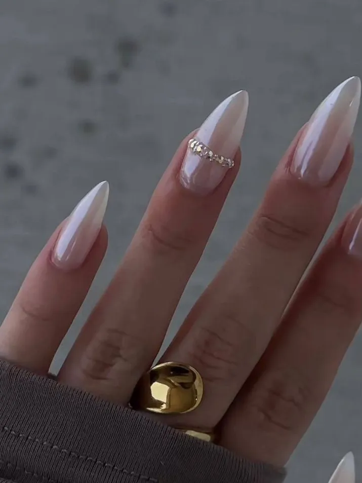 Pearly white stiletto nails, elegant design, minimalistic embellishment