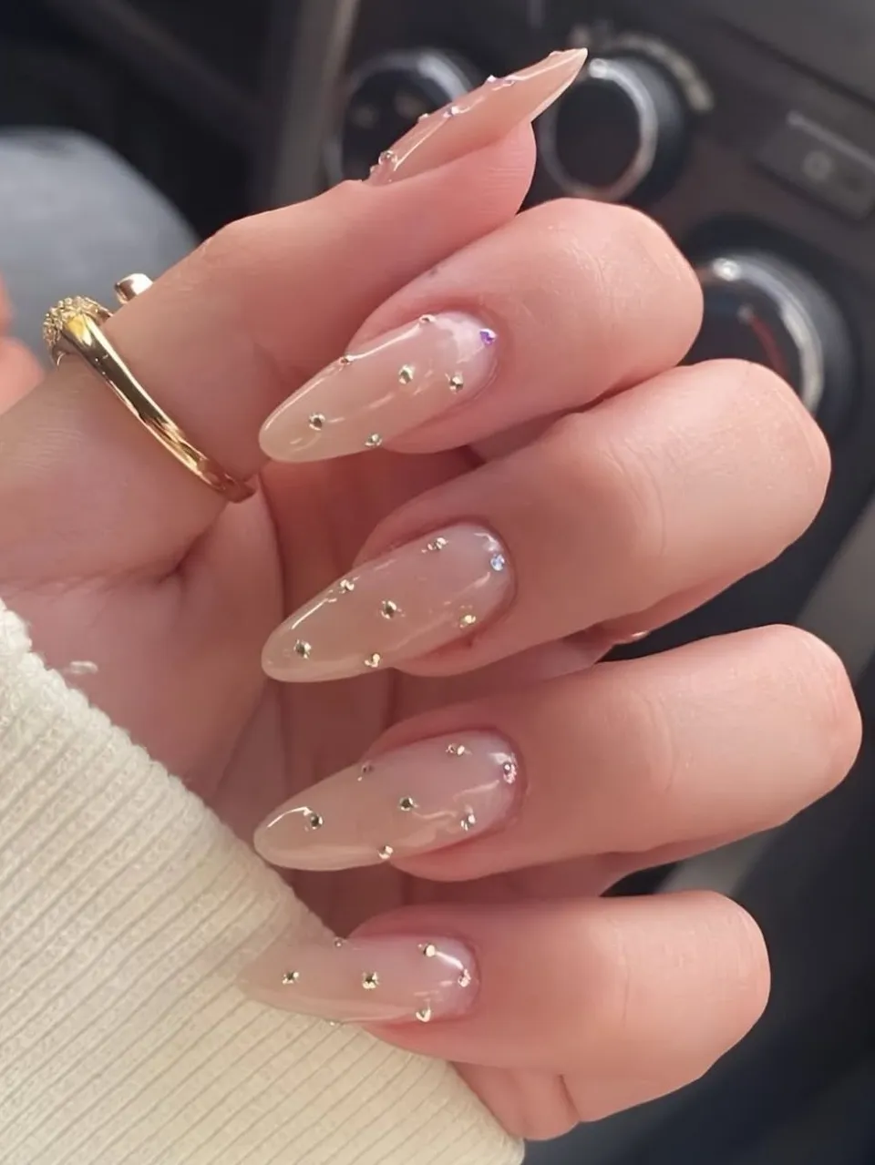 Nude nails with pearl embellishments, stiletto shape