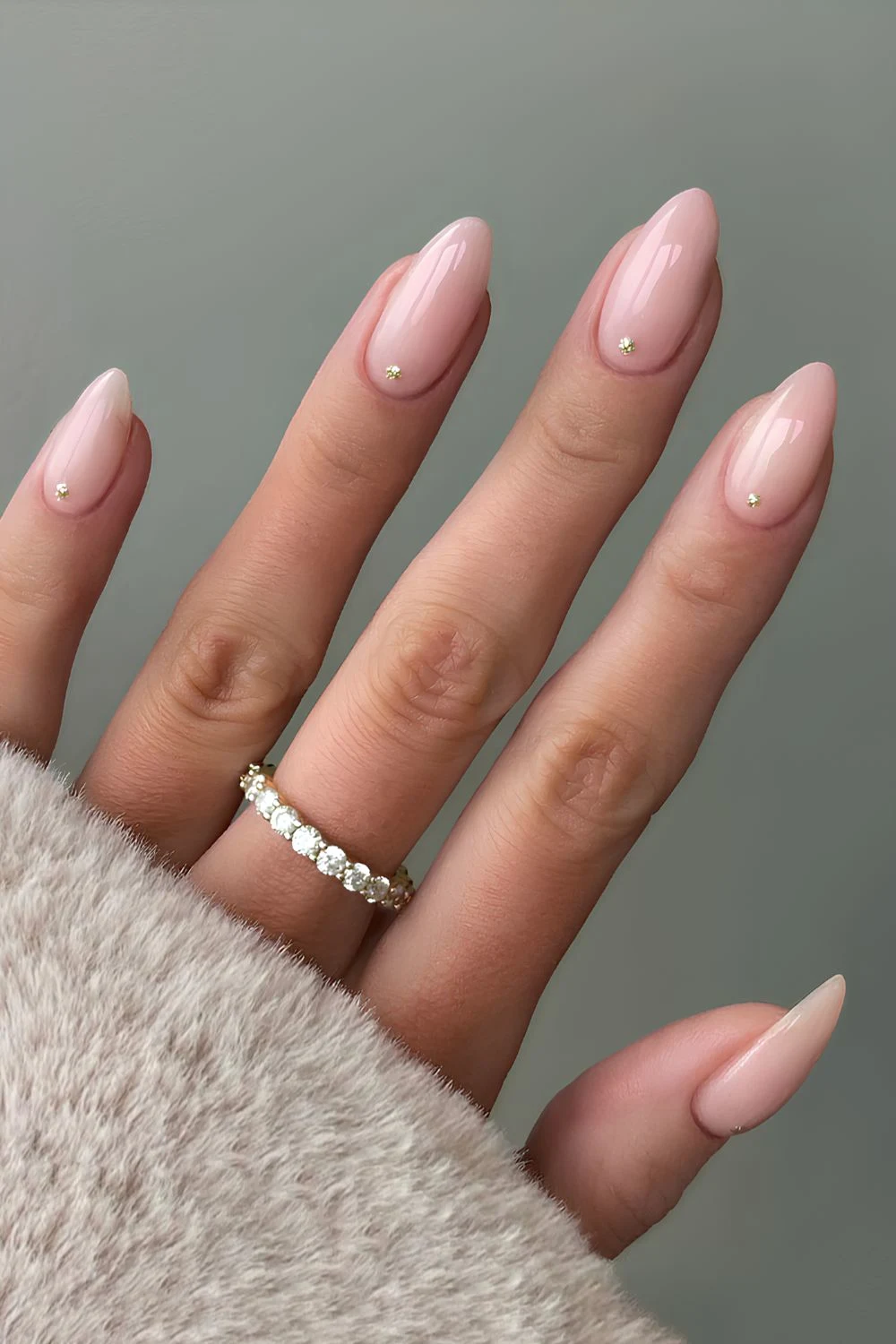 Nude nails with small gems, almond shape