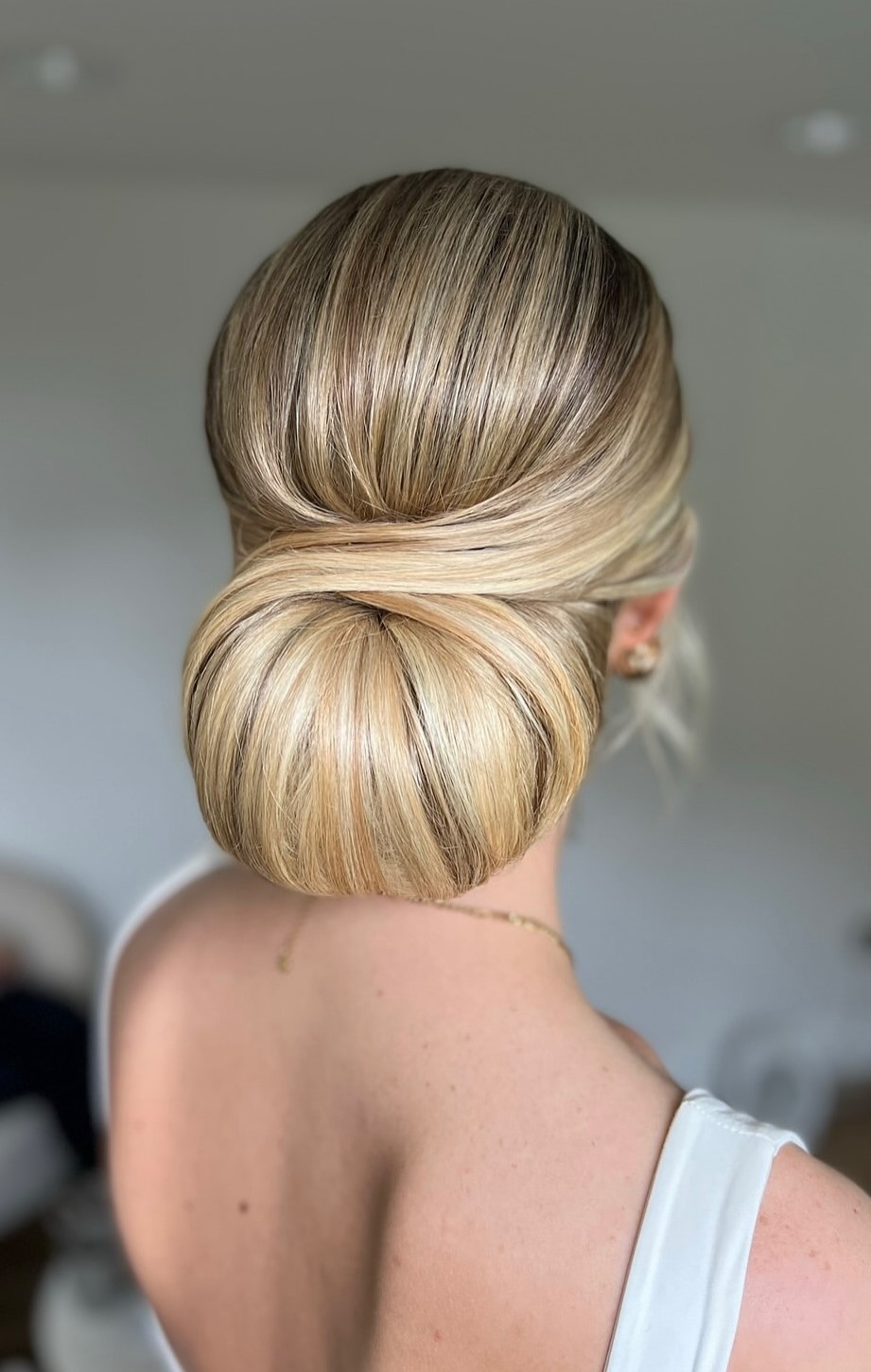 Sleek low chignon with a polished finish