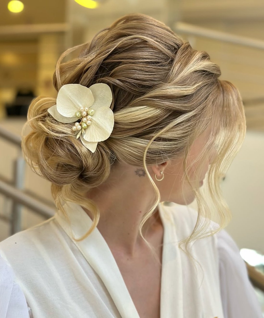 Twisted bun with floral decoration for a romantic look