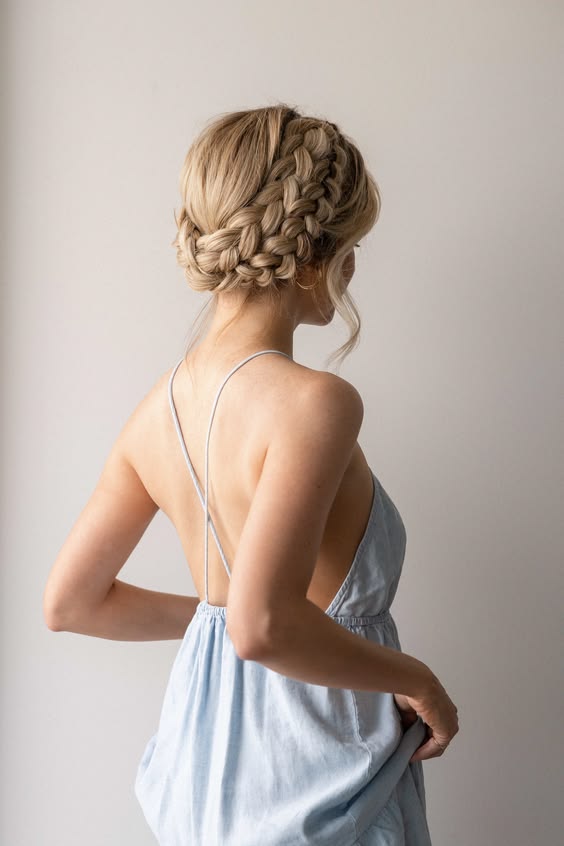 Chic braided crown updo with soft tendrils
