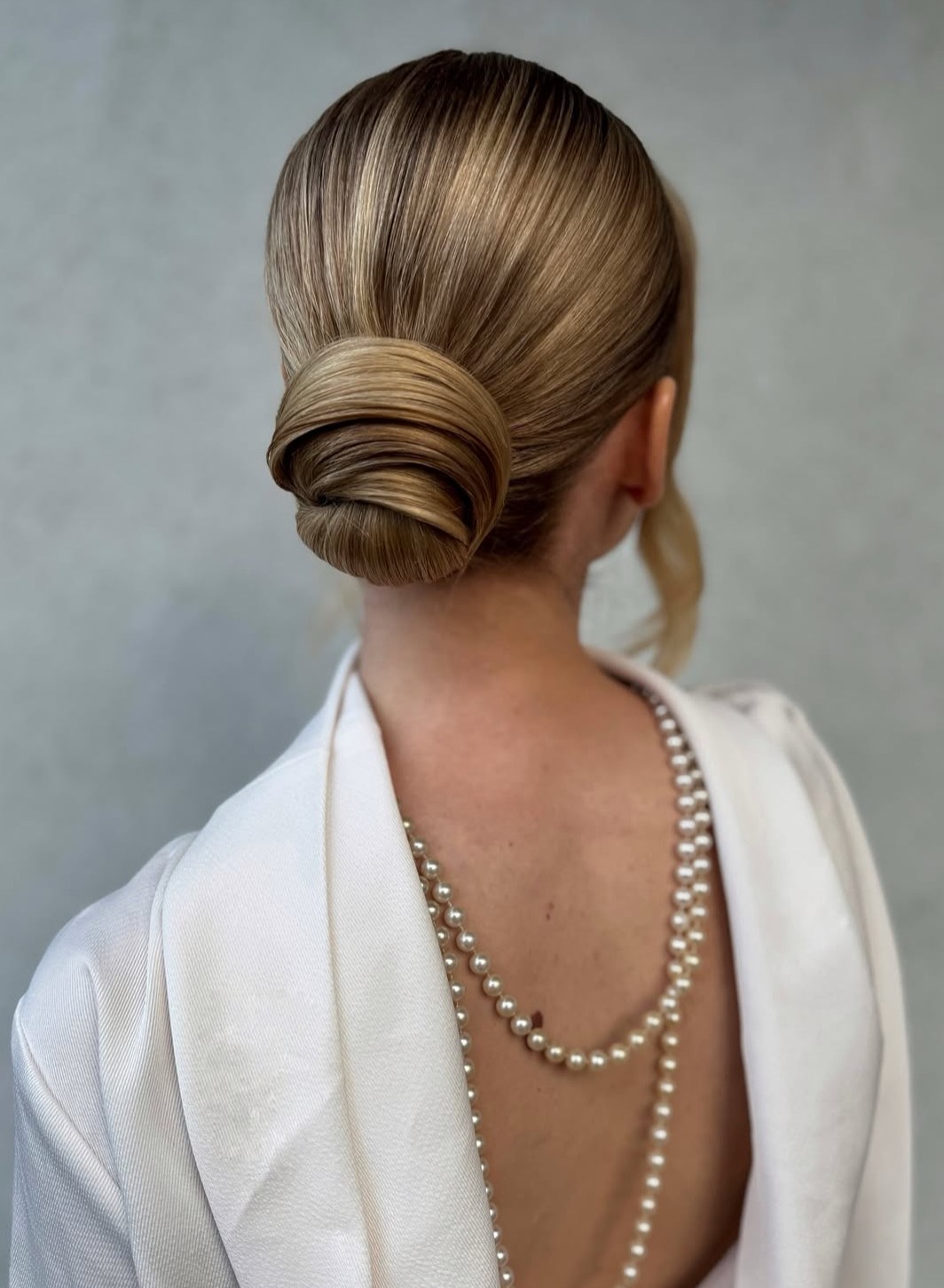 Sleek classic chignon with polished finish