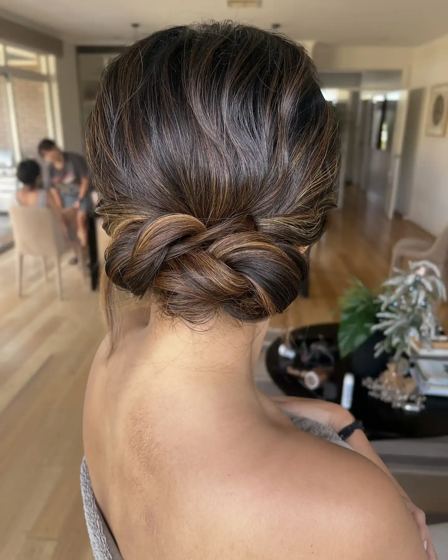 Effortless twisted bun with subtle highlights
