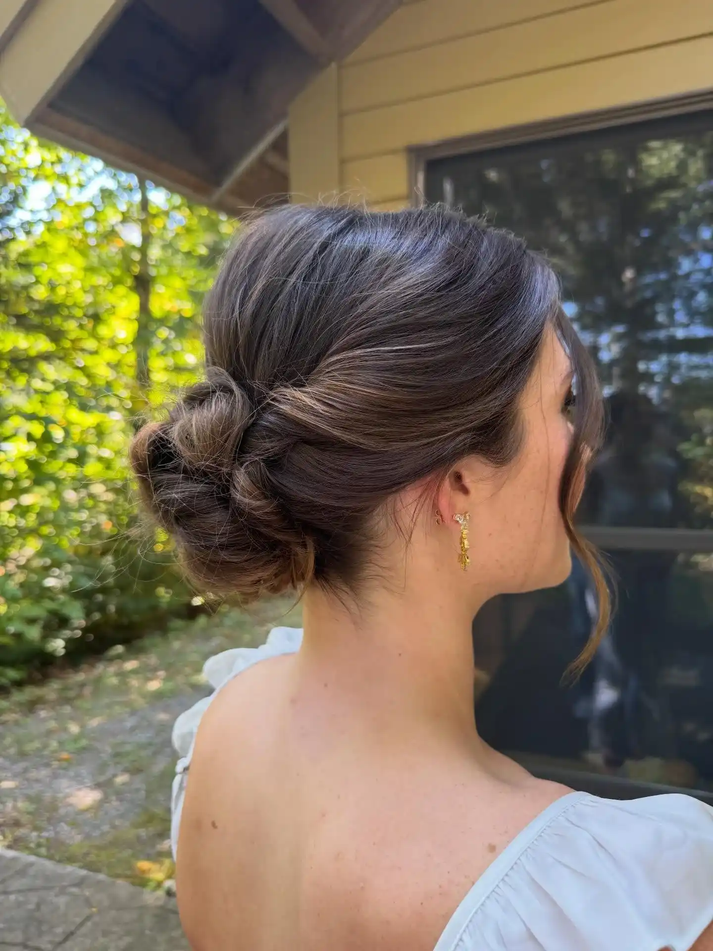 Relaxed twisted low bun with natural finish