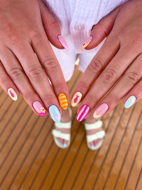 Playful candy stripe nails with vibrant, colorful designs.