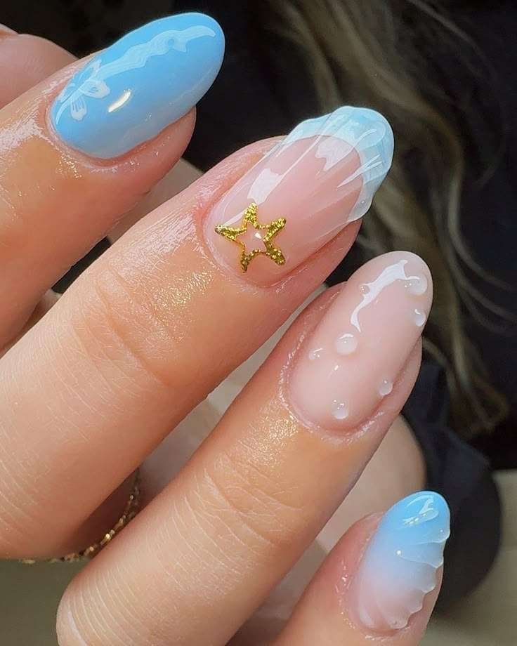 Oceanic wave nails with starfish charm for a seaside theme.