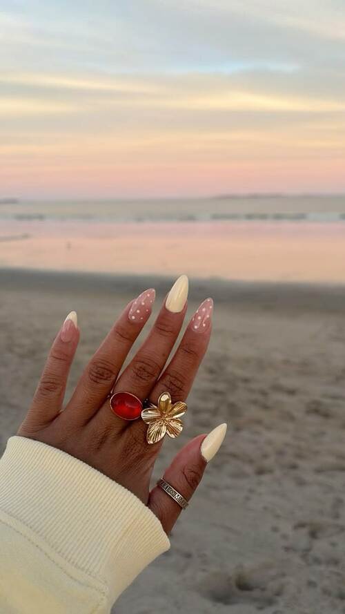 Pastel polka dot nails with playful design.