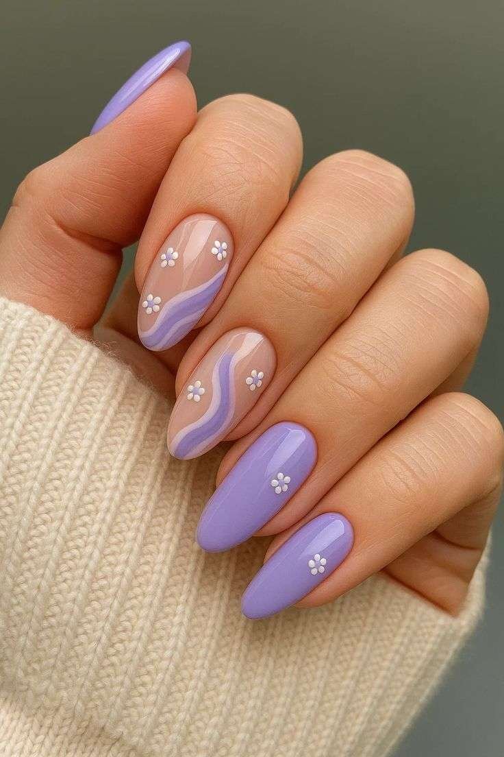 Lavender wave nails with floral accents.