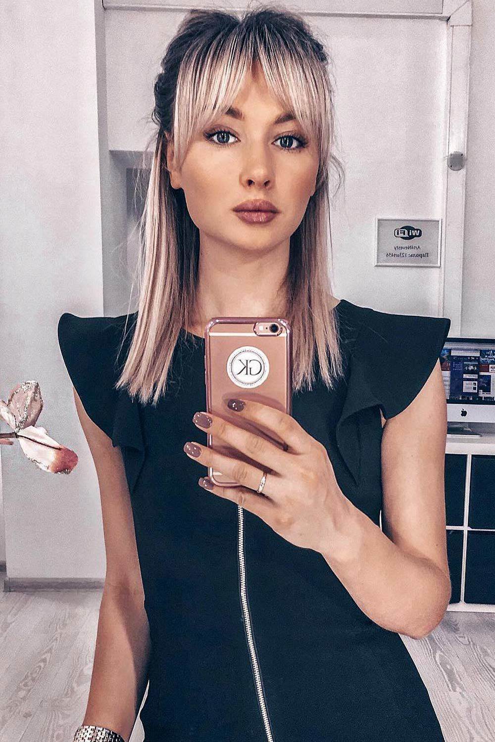 Chic half-up with wispy bangs and sleek finish