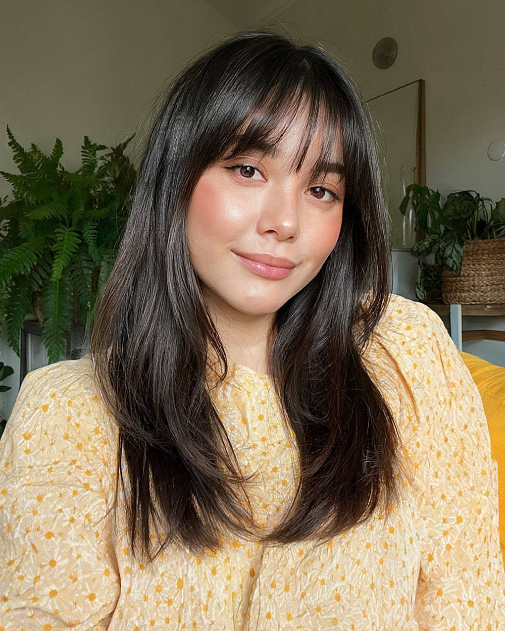 Sleek layers with wispy bangs and shine